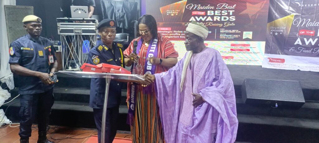 Mr Zacheus presenting an award to one of teh beneficiaries