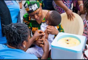 child being immunised by FCTA official