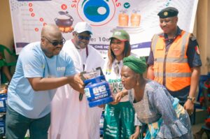 Dr Adam presenting the gas cylinders to one of the beneficiaries