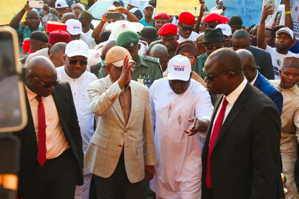 Barr Wike waving at residents of AMAC when he came